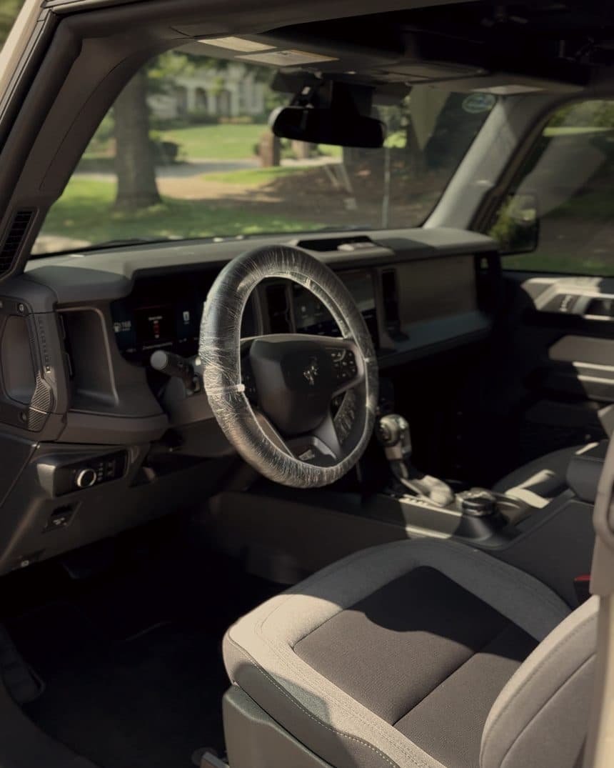 Front cabin of a Ford Bronco with grey cloth seats