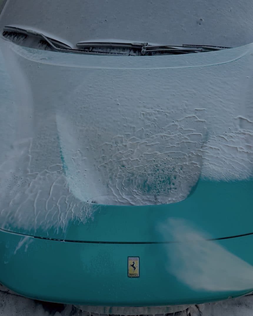 Foam sitting on the hood of a Ferrari during the pre-wash