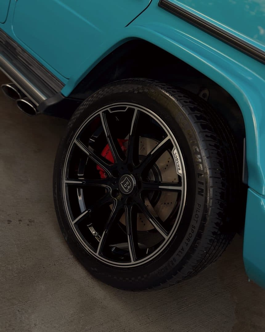 Wheel, red caliper, and exhaust tips of a Mercedes G63