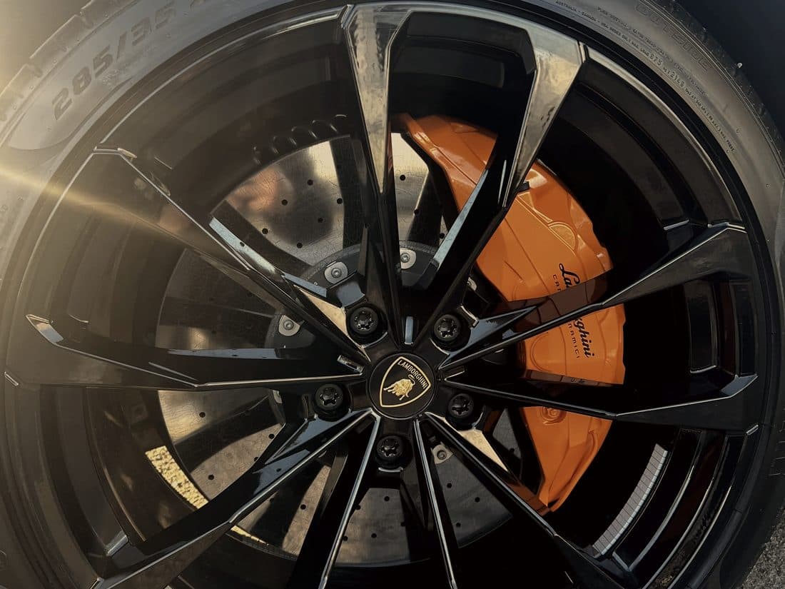 Wheel and orange brake caliper on a Lamborghini