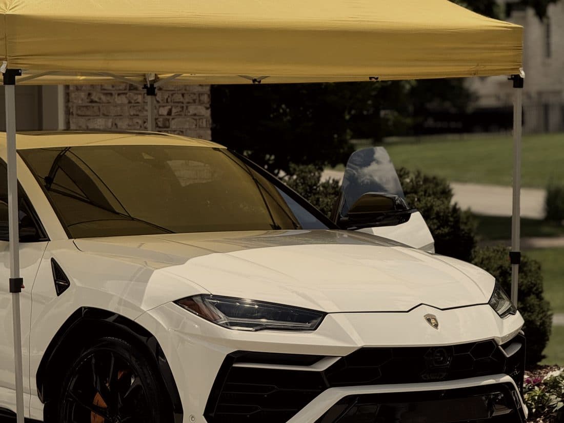 White Lamborghini Urus parked under the mobile canopy