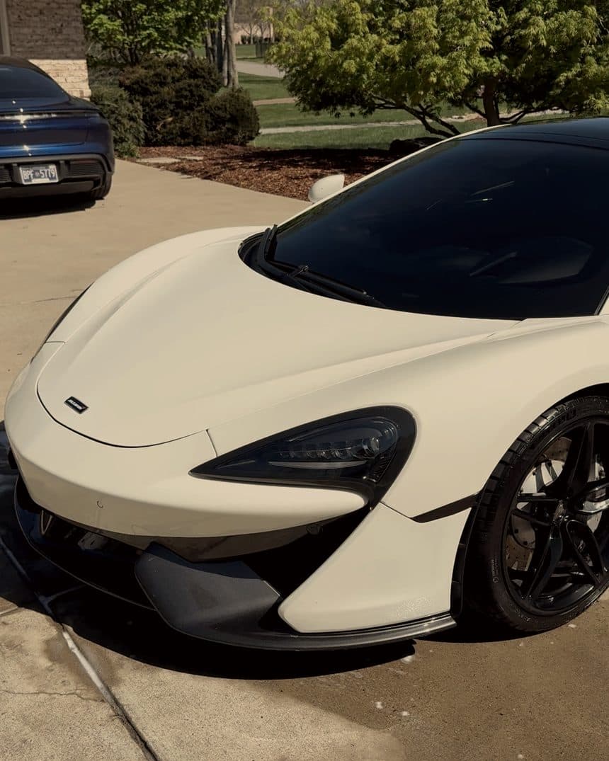 White McLaren 570S parked on a driveway