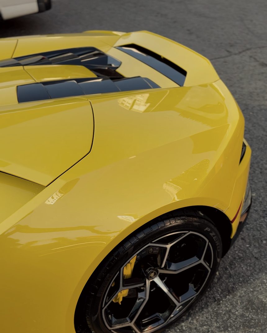 Rear quarter and wheel of a yellow Lamborghini Huracan
